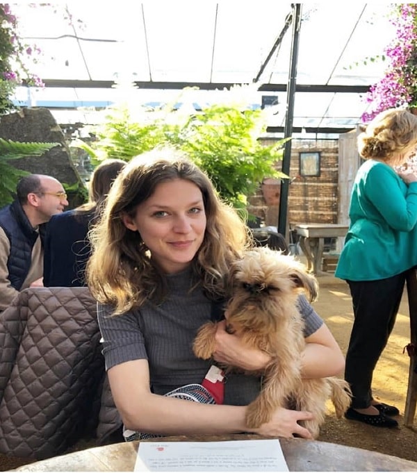 Emma Louise Saunders holding her pet dog.